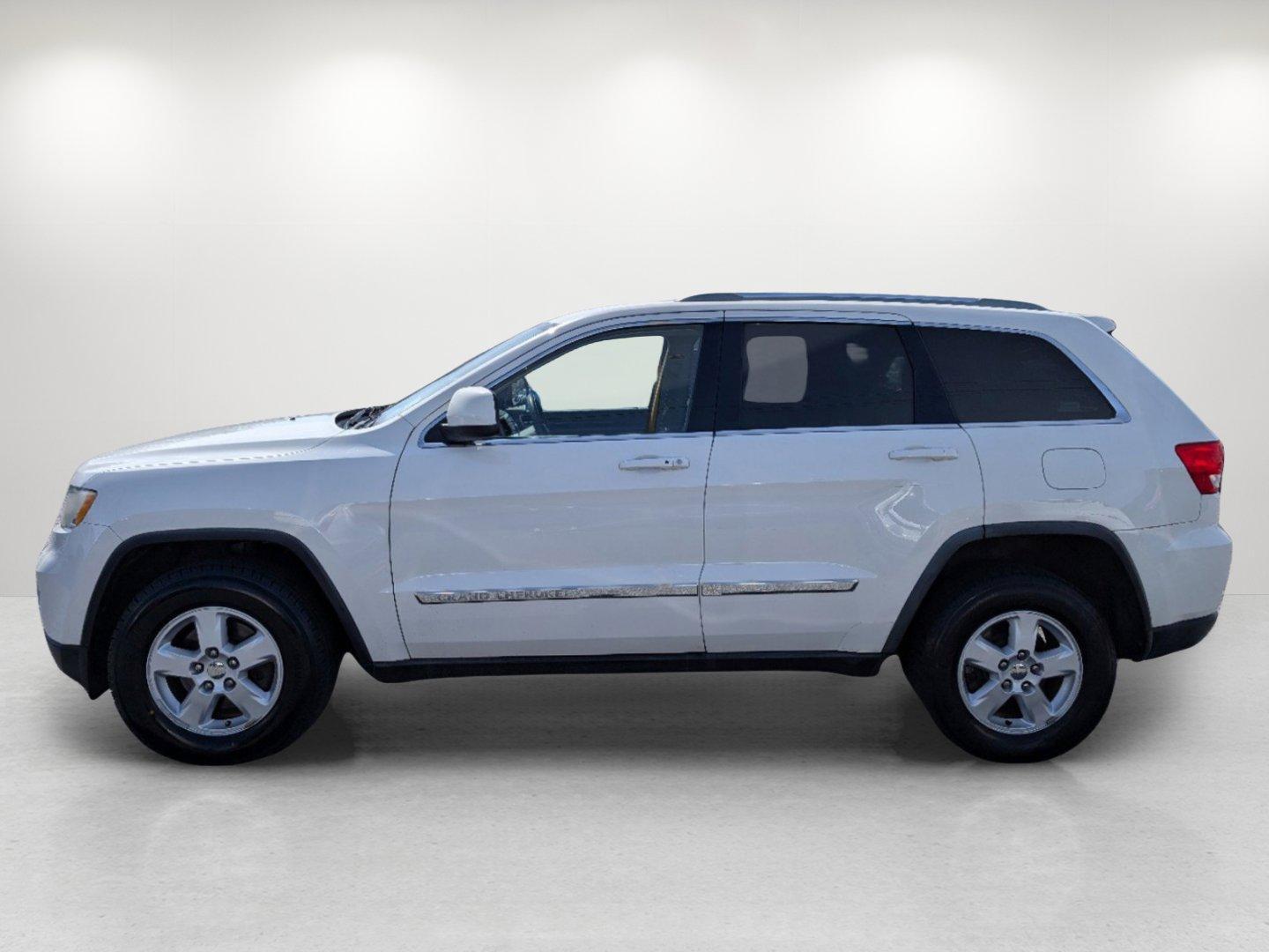 2012 Stone White /Dark Graystone/Medium Graystone Jeep Grand Cherokee Laredo (1C4RJFAG1CC) with an Gas/Ethanol V6 3.6L/220 engine, 5-Speed Automatic transmission, located at 804 22nd Ave, Phenix City, AL, 36870, (334) 297-1860, 32.484749, -85.024475 - 2012 Jeep Grand Cherokee Laredo - Photo#7